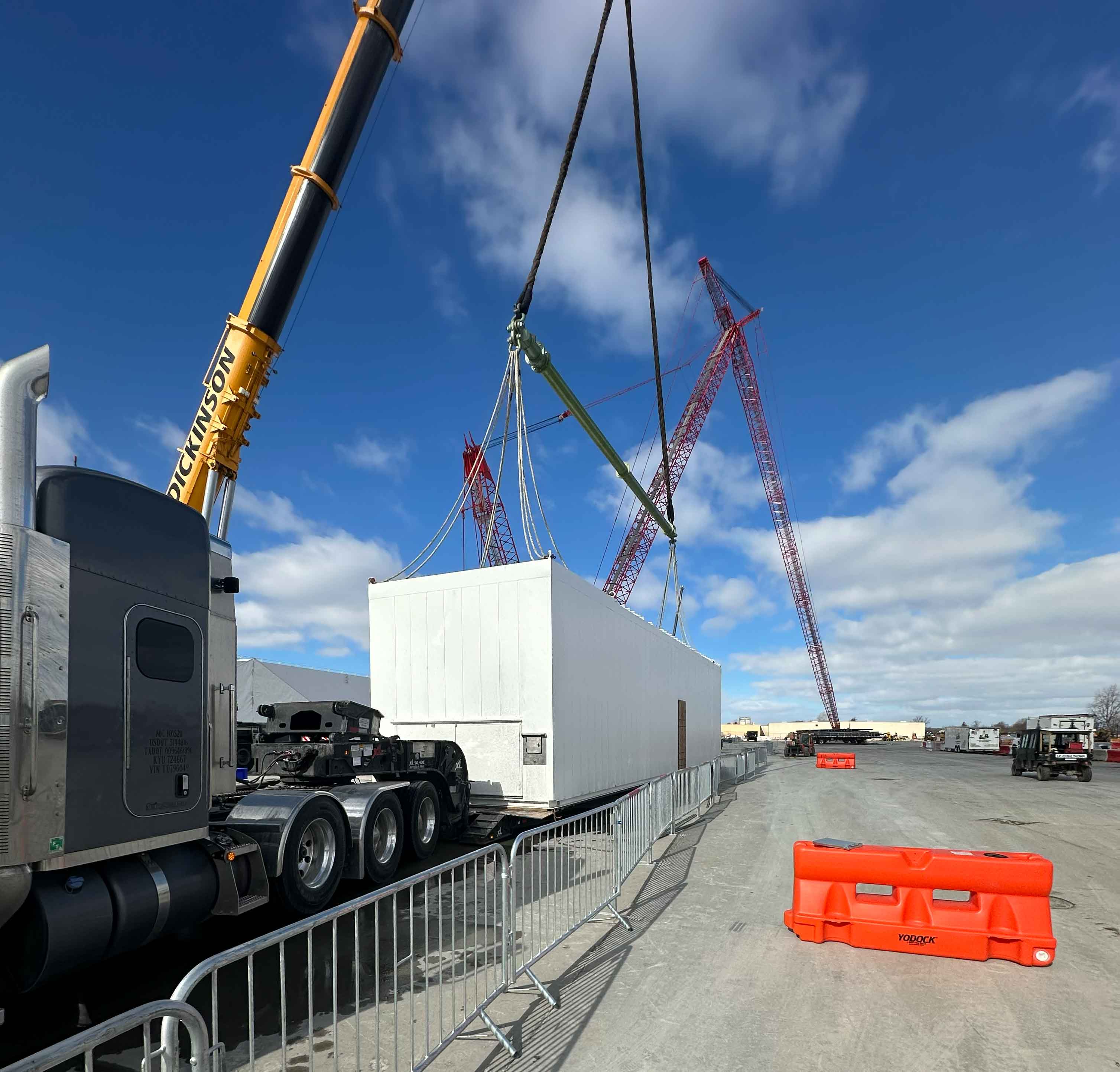 Large industrial generator being transported on oversize flatbed trailer